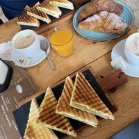 Avo on toast (Italian way), vegan croissants with fruit jam, soy cappuccinos, and fresh orange juicee  at Caffe Cactus in Golfo Aranci