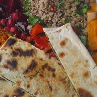 Spinach and onion flatbread, with a selection of salads. I've been craving this ever since! at Busy Beans Cafe in Redhill