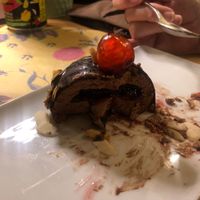 Chocolate ice cream with a cherry sauce, coated in a chocolate shell, flakes almonds and a glacé cherry on top!  at I Morgante Bottegabistro in Agrigento