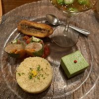 Couscous, plantain, edamame tofu, summer rolls, and some sort of jellied dish. at Cafe Banmari in Mishima