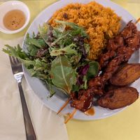 Sampler plate with pinchos (bbq chicken skewers). Hot sauce on the side in a little dish, that was really good too! at Casa Borinqueña in San Francisco