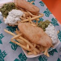 fish and chips £7.95 - mushy peas were really good, had mint or something in. 'fish' was nice enough and good portion size.  at Oowee Vegan in Brighton