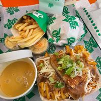 Sneaky clucker & fries, cheeze sauce and loaded chick'n waffle fries at Oowee Vegan in Brighton