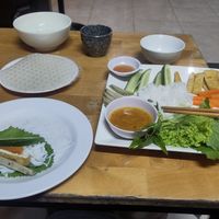 asked the lady how to roll the spring rolls at Quan Chay Buffet Lac Tam Vegan in Hue