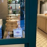 Happy cow sticker on the front window!  at Holy Llama - Sintagma in Athens