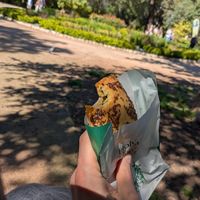 Enjoying a spinach pie from Holy Llama in the sun at the national park at Holy Llama - Sintagma in Athens