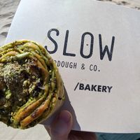 Pesto Bun (first i thought it's pistachio) but very delicious! at Slow Sourdough & Co in Almada