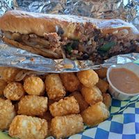 Philly Cheesesteak and Tater tots with Chipotle dipping sauce.  at Happy Vegan in Fountain Valley