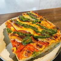 Pizza slice with pesto  at Miss Sina in Sydney