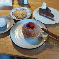 Raspberry filled donut, Bounty cake, raspberry macaroni and a simple chocolate chip cookie 😊 at Miss Sina in Marrickville