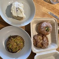 Clockwise from top: bestselling cinnamon scroll, pistachio cream doughnut, pear fritter, Dubai Chocolate cookie  at Miss Sina in Marrickville