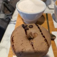 Coffee doughnut and a cup of oat milk  at Espresso Mafia  in Girona