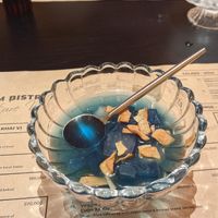 Complimentary sugar water with crispy coconut dessert at Cai Mam Bistro - Signature Vegan in Hanoi