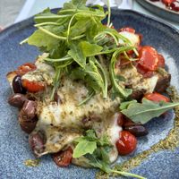 Sumptuous vegan bruschetta with meltable vegan cheese, tomatoes, rocket, and olives  at Baroque Le Bistrot in Kefalonia