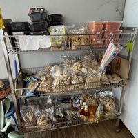 They sell a few cooking items. The black containers at the top left are vegan instant noodles, just add boiling water, for 80 baht.  at Zing Zing Che - ชิ้งชิงเจ in Udon Thani