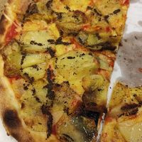 Pizza with potatoes, truffles, tomatoes and vegan mozzarella at Pizzano in Alba Iulia