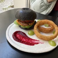 Burger with black bun, onion ring, and beet sauce   at ARP - 아르프 in Busan