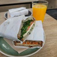 Vegan caprese and vegan Thai tofu with orange juice at KoRo Café in Berlin