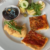 Selection from all you can eat vegan table - scrambled tofu, bread with vegan cheese, muffin, pizza  at PiranArt Restaurant & Gelateria & Caffeteria in Piran