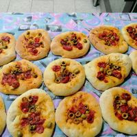 Vegan home made bread with olives, tomato and localy produced olive oil. Like small pizza. at PiranArt Restaurant & Gelateria & Caffeteria in Piran