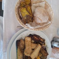 Hearty brunch of grilled tofu and veg on a bulgar wheat(?) base with homemade roll and turmeric bread at PiranArt Restaurant & Gelateria & Caffeteria in Piran