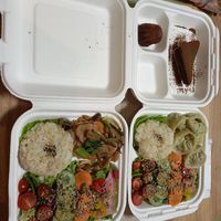 Ginger stirfry (soy protein and mushroom) on the left, dumplings on the right, above sits our desserts - chocolate cake and cannele. at Zirael Vegan Restaurant in Kyoto