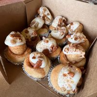 Bite-sized baby buns topped with cream cheese frosting and pecans at Cinnaholic in Carmel