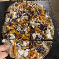 Pinsa Messico con zucca al rosmarino, cavolo rosso peperoncino a fettine e strachicco  at Veghometro in Rome