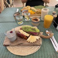 Hammam chill breakfast - avo and hummus on toast, chia pudding, fruit, juice and coffee! Pikala breakfast in the background (veggie)  at Pikala Cafe in Marrakech