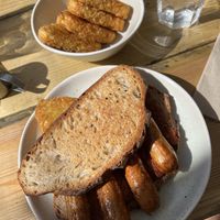 Vegan sausage sandwich and hashbrowns  at The Nectar House in Bristol