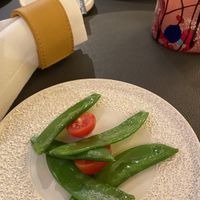 Amuse-bouche a cura dello chef con taccole e pomodorini, schiacciata e pane, panino all’anice  at Locanda Degli Artisti in Canazei