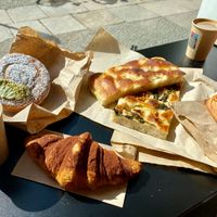 Focaccia, savory pastries, chocolate cornetto, and girella pistacchio at The Sanctuary in Berlin