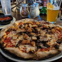 Small pizza with Vegan chicken, vegan cheese, and mushrooms at Sticks and Stones Clay Oven Pizza in Greensboro