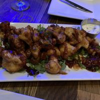 Vegan cauliflower tempura wings with Korean bbq sauce.  Note the cup of non-vegan sauce that came with it. Not cool    at Bar Grazie in Massapequa Park