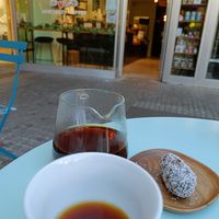 Front of store, black coffee and an energy bar at Curious Buds in Luxembourg City