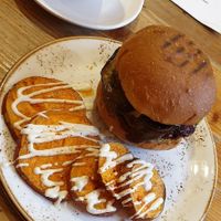 Burger, sweet potato slices and yummy hot drink at Wild Food Cafe in London