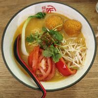 Creamy White Vegan TanTan Men (R24): Spicy vegan miso ramen with sesame seeds, soy milk curry croquette and tomatoes at Takumi Chicken & Veggie in Aachen