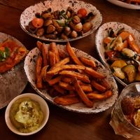 Tomato Bread, grilled champignons, sweet potato fries, grilled vegetable with sunflower seeds, falafel salad and guacamole at Panoramico in Rostock