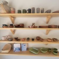 Tasteful pottery and high vibe books at Panluna Panadería Vegana - Cafe Piyo in Huatulco