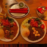 Pumpkin curry with salad, green chile sauce on the side, palik paneer with salad, homemade chai tea.  at tschüüüsch - Vriends & Cosy Comfort Food in Berlin