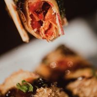 Vegan Hot Roll: Fried sweet potato sheet, stuffed with sun-dried tomato and avocado, topped with tarê, sweet pepper jelly and chives. at Makê Sushi Pub in Natal