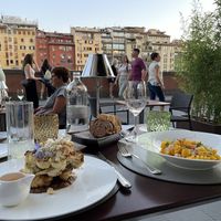 Vegan cauliflower steak on the left with a stunning view of Ponte Vecchio at sunset  at Caffè dell'Oro in Florence