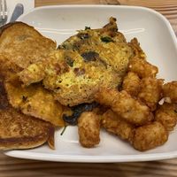 Just egg omelette with tomato, spinach and mushroom, with toast and tater tots  at Vegan Grill - Upper East Side in New York City