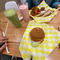 French toast with sausage and sweet potato fries, chicken sandwich, strawberry milkshake and green smoothie.  at Vegan Grill - Upper East Side in New York City