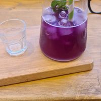 Homenade lemonade syrup you swirl into blue pea flower which turns out purple at Heal - Coffee, Lifestyle & Gifting in Harrogate