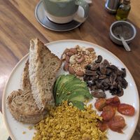Tofu revuelto con pan, palta, frutos secos, hongos, y tomates + un matcha latte con leche vegetal at Chicama in Buenos Aires