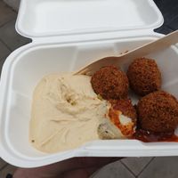 4 piece falafel with hummus and a little bit of chilli sauce at Falafel King in Manchester