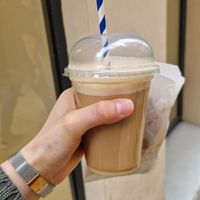 Iced latte with almond milk and two vegan cookies at Bertani Café in Malaga