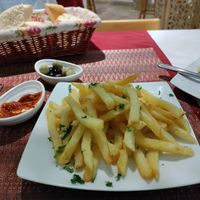 Huge serve of fries. Free olives, harissa and bread at Les Arcades in Tozeur