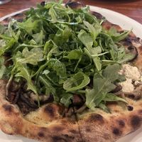 Vegan ricotta, mushrooms and arugula with an olive oil and roasted garlic base.   at Pizzeria Toro in Durham